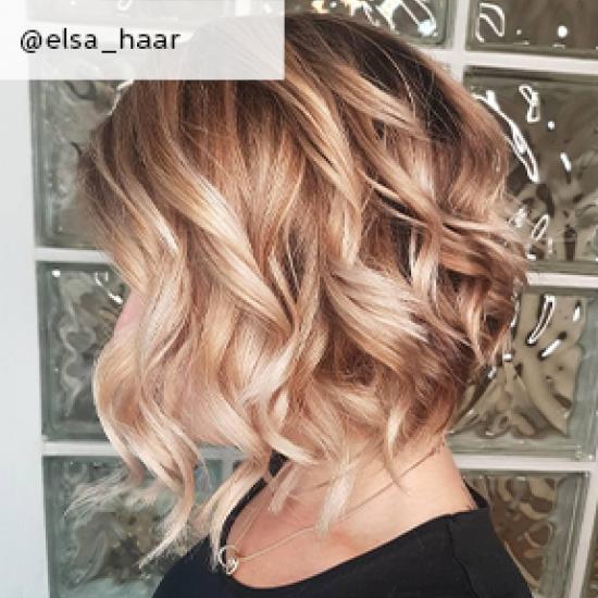 Side profile of woman with curly, blonde balayage bob, created using Wella Professionals.