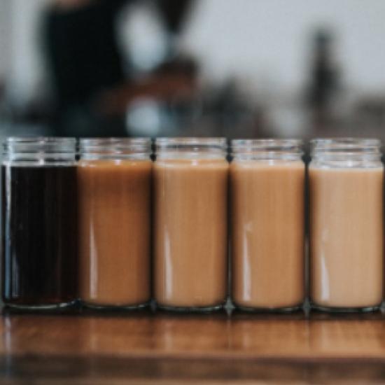 Row of jars filled with coffee.