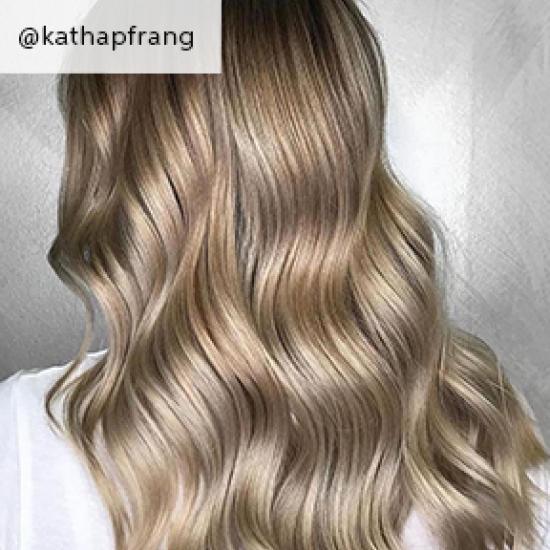 Wavy hair with baby highlights, created using Wella Professionals