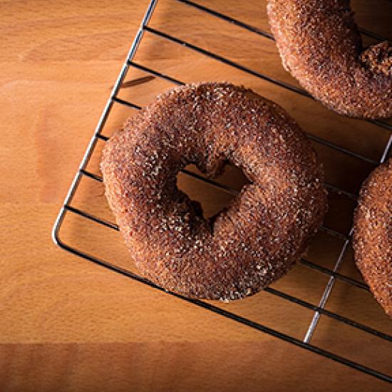 Image of chocolate donuts covered in sprinkles