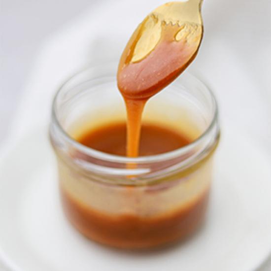 Image of creamy butterscotch being poured into jar