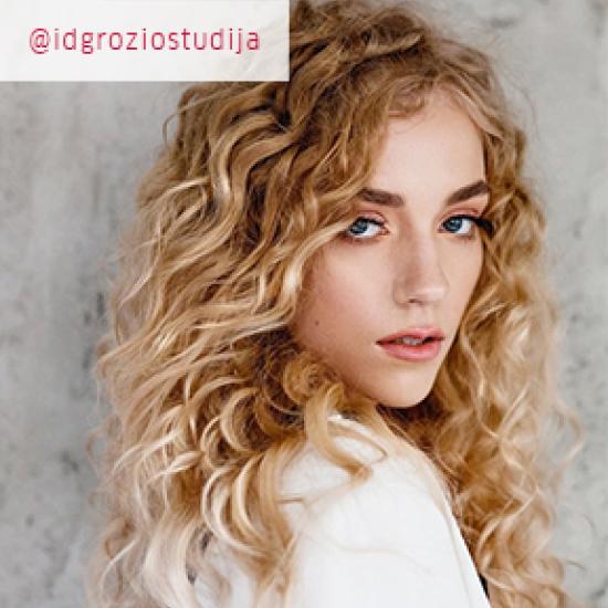 Photo of woman with curly, Powdered blonde hair, created using Wella Professionals.