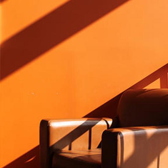 Women with long copper hair, copper paper, copper chair and copper leaves