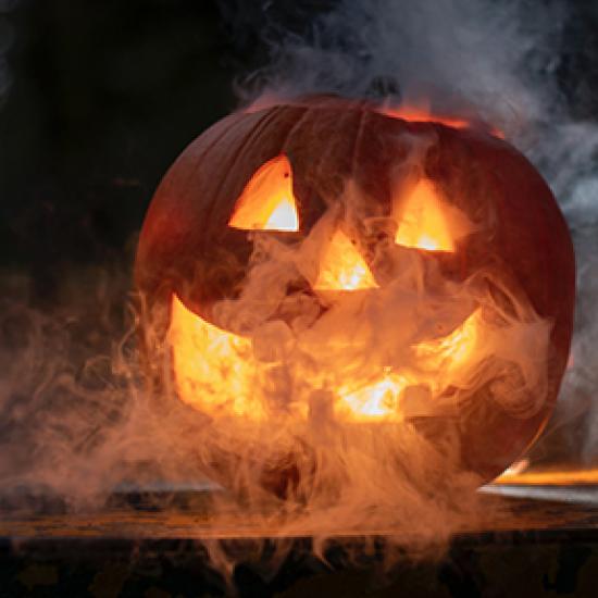 Image of a carved pumpkin with lantern inside