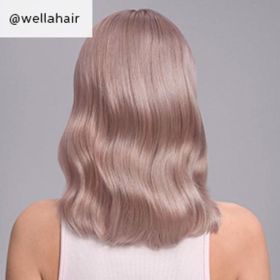 Back of woman’s head with mid-length, wavy, lilac blonde hair, created using Wella Professionals.