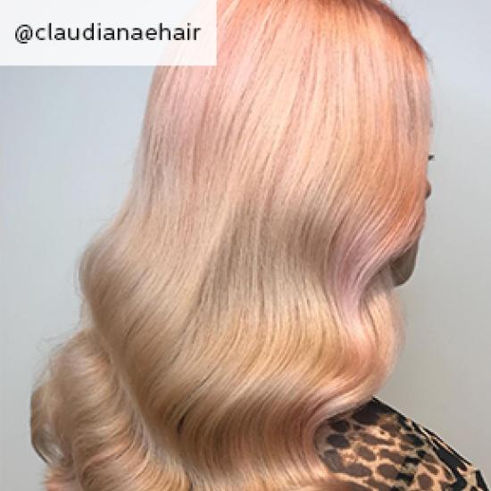back of woman’s head with subtle peach coloured waves