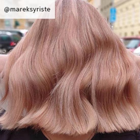 back of woman’s head with mid-length hair in peach blonde