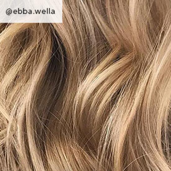 Close-up of sandy blonde, curly hair, created using Wella Professionals.