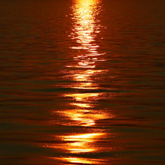 Image of sea with red sun reflection
