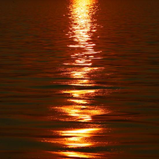 Image of sea with red sun reflection
