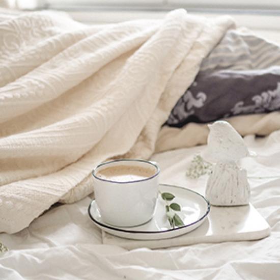 Coffee on cream bed sheets 