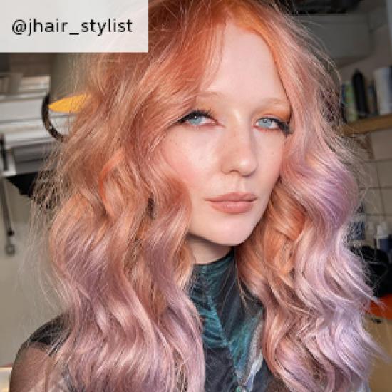 A woman with pink pastel tone hair and soft curls