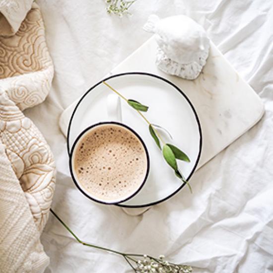 coffee on white bedsheets 