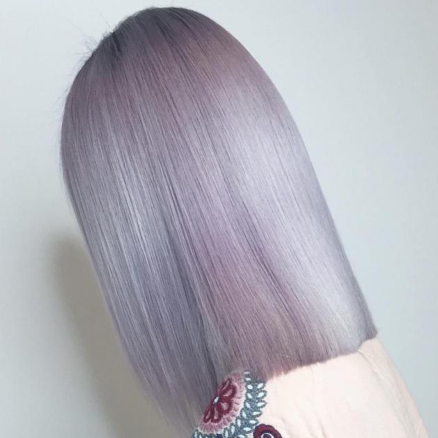 Woman with straight, violet blonde, mid length hair