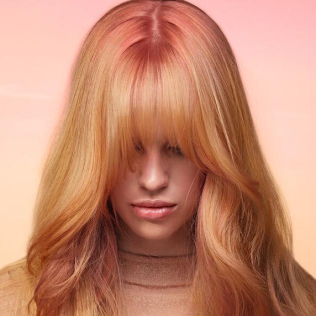 Model with long, golden blonde hair, rose pink roots and rose pink highlights.