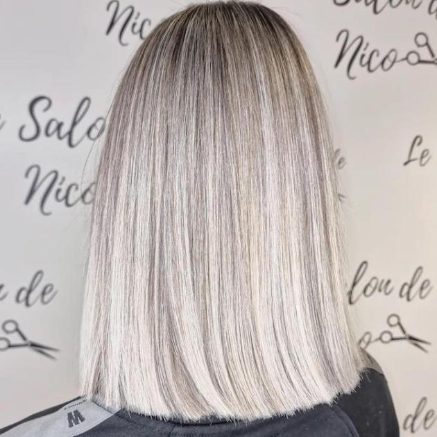 Back of woman’s head with mid-length, super-straight, glossy gray hair.