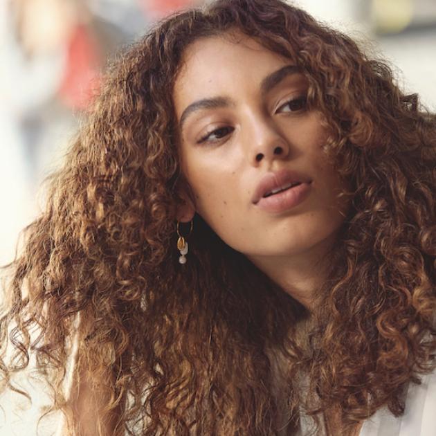 Model with curly hair, styled using Wella Professionals products