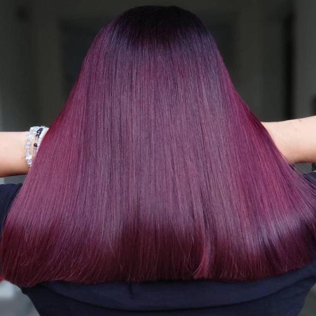 Back of woman’s head with super-straight, mid-length, plum hair, created using Wella Professionals.