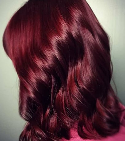 Woman with medium length hair in berry rich color 