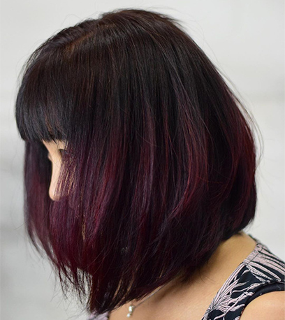 Short, burgundy cherry cola hair color, created using Wella Professionals products