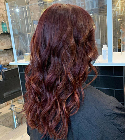 Curly cherry cola hair colour, created using Wella Professionals products