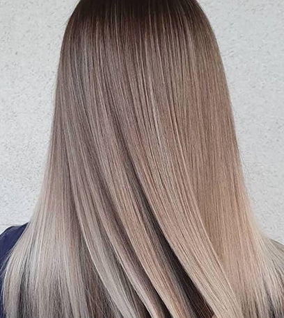 Back of woman’s head with long, straight, dark ash blonde hair, created using Wella Profession-als.