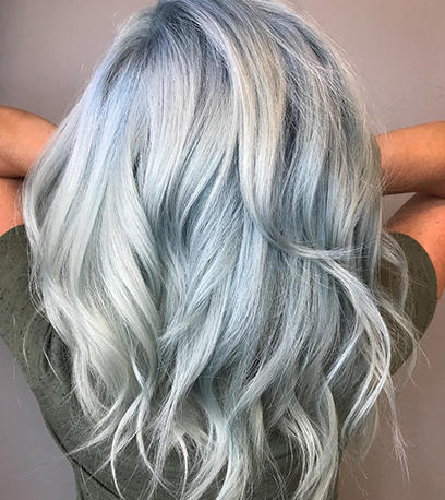 Woman with long wavy light denim blue hair using Koleston Perfect