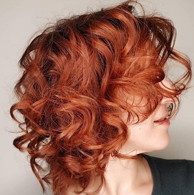 Woman with curly leather red hair, created using Wella Professionals