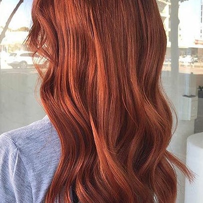 Woman with wavy leather red hair, created using Wella Professionals