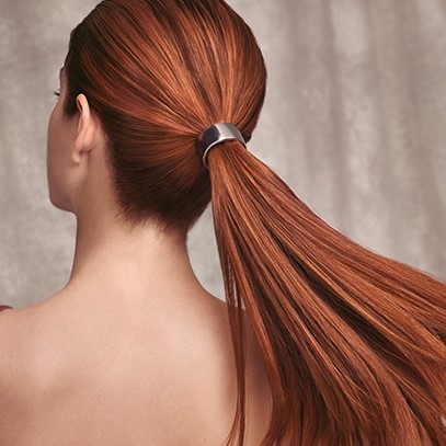 Woman with a pony tail of leather red hair, created using Wella Professionals