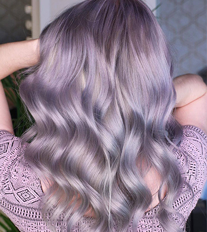 Back of woman’s head with mid-length, wavy, pastel lilac hair, created using Wella Professionals