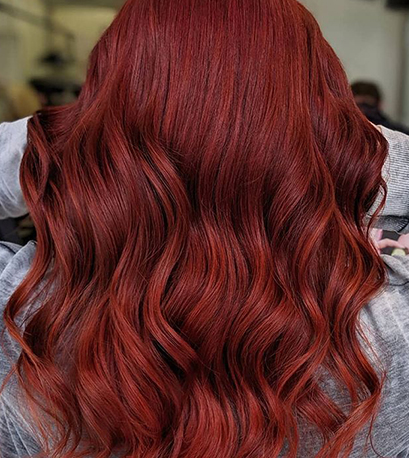 Muted red hair color, created using Wella Professionals