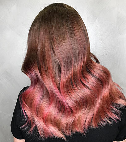 Woman with long wavy rose brown hair using Color Touch