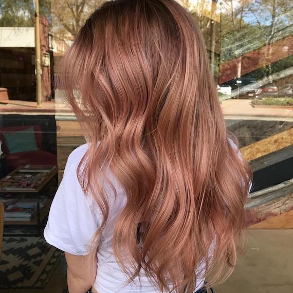 Model with long, wavy, pink bronde hair, created using Wella Professionals