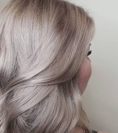 Side of womans head showing pearlescent silver hair, created using Wella Professionals