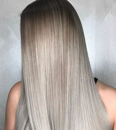 Alt tag: Side of womans head showing glossy silver hair, created using Wella Professionals 