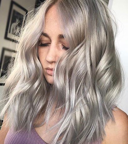 Curled icy silver hair, created using Wella Professionals