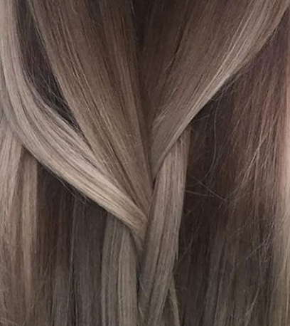 Close-up of loosely braided, stone blonde sombre hair, created using Wella Professionals.